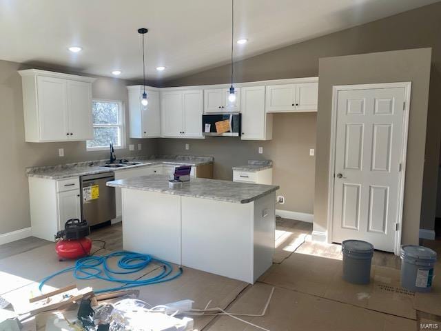 kitchen with white cabinets, appliances with stainless steel finishes, and a kitchen island