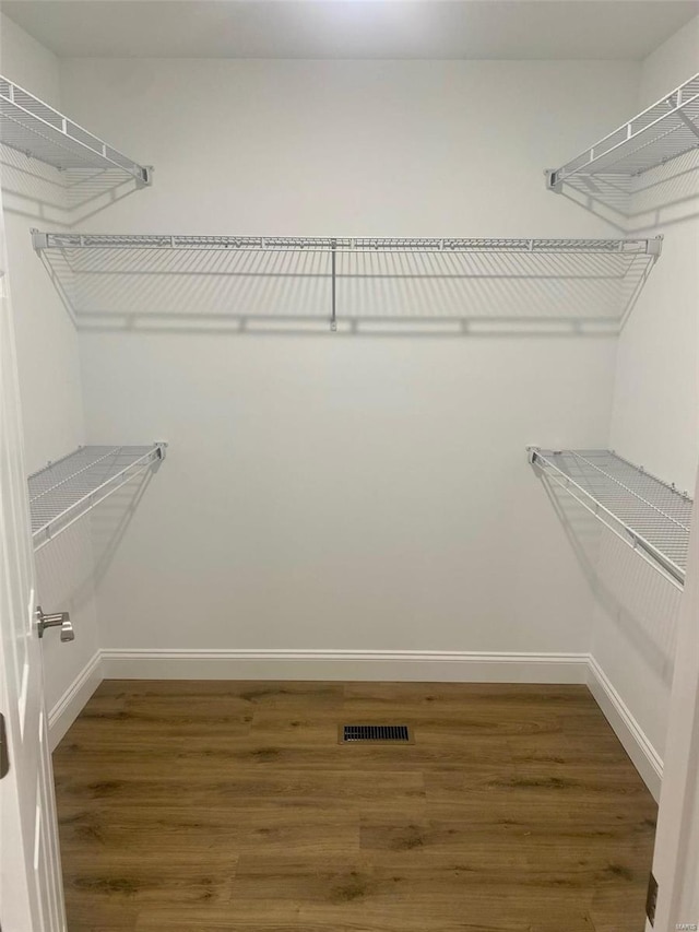 spacious closet with visible vents and wood finished floors