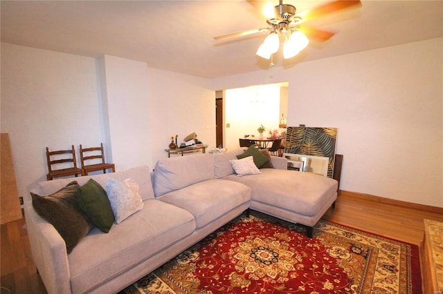 living room with ceiling fan and hardwood / wood-style flooring