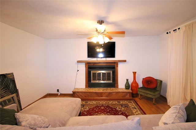 living room featuring hardwood / wood-style floors and ceiling fan