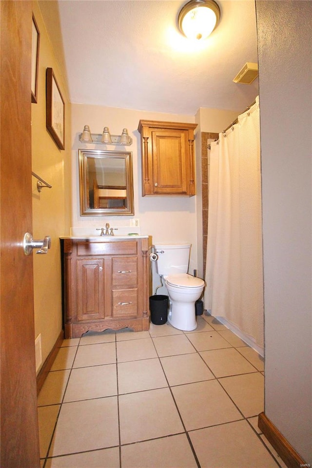 bathroom featuring vanity, toilet, a shower with curtain, and tile patterned floors