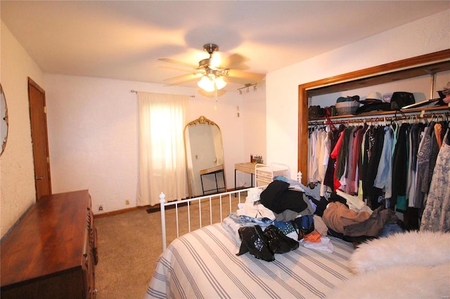 carpeted bedroom with a closet and ceiling fan