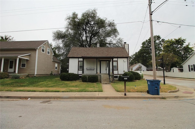 bungalow-style house featuring a front lawn and covered porch