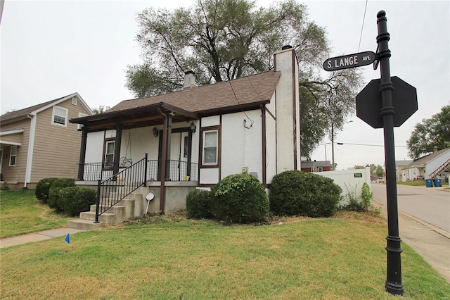 view of front of property with a front lawn and a porch