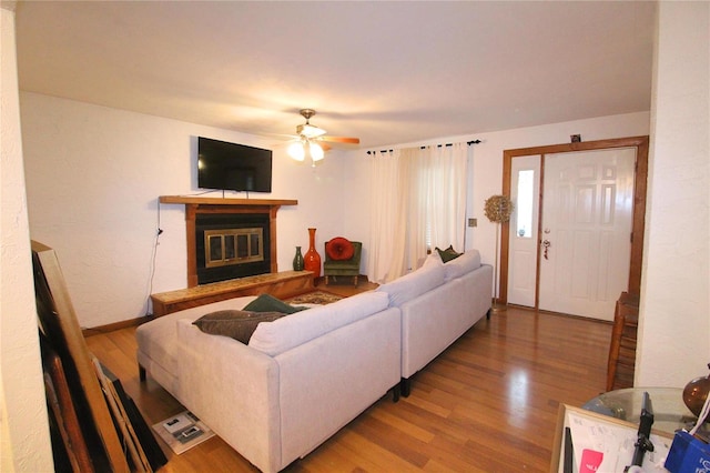 living room featuring ceiling fan and wood-type flooring