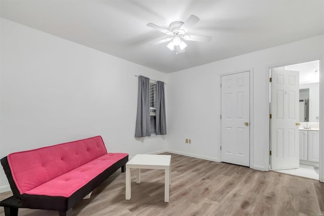 living area with light hardwood / wood-style flooring and ceiling fan