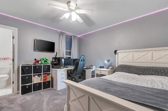 bedroom featuring light colored carpet, connected bathroom, and ceiling fan