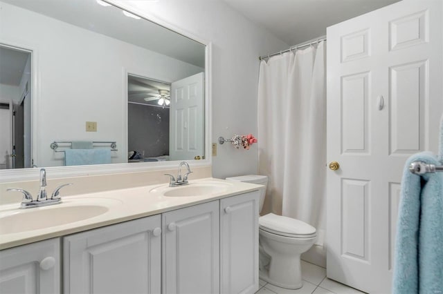 bathroom featuring vanity, toilet, tile patterned flooring, and ceiling fan