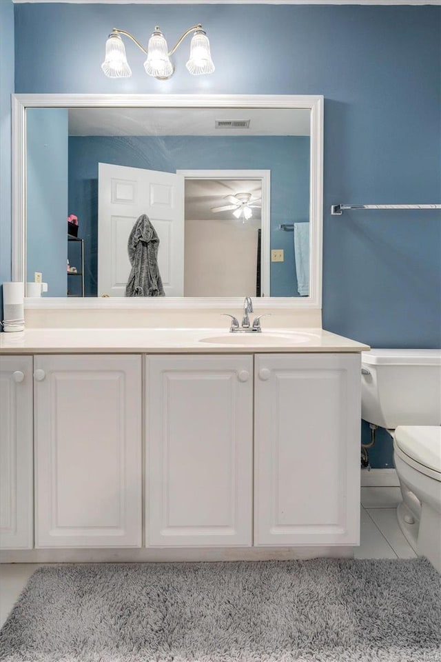 bathroom featuring vanity, toilet, and tile patterned flooring