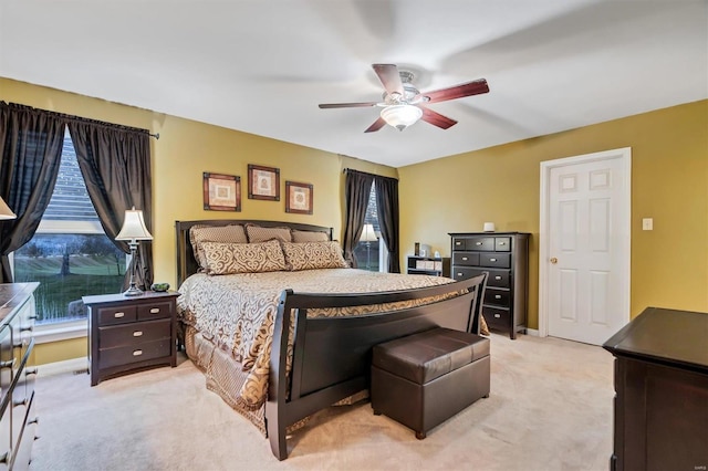 bedroom featuring light colored carpet and ceiling fan