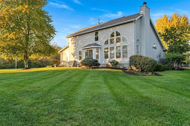 rear view of house with a lawn