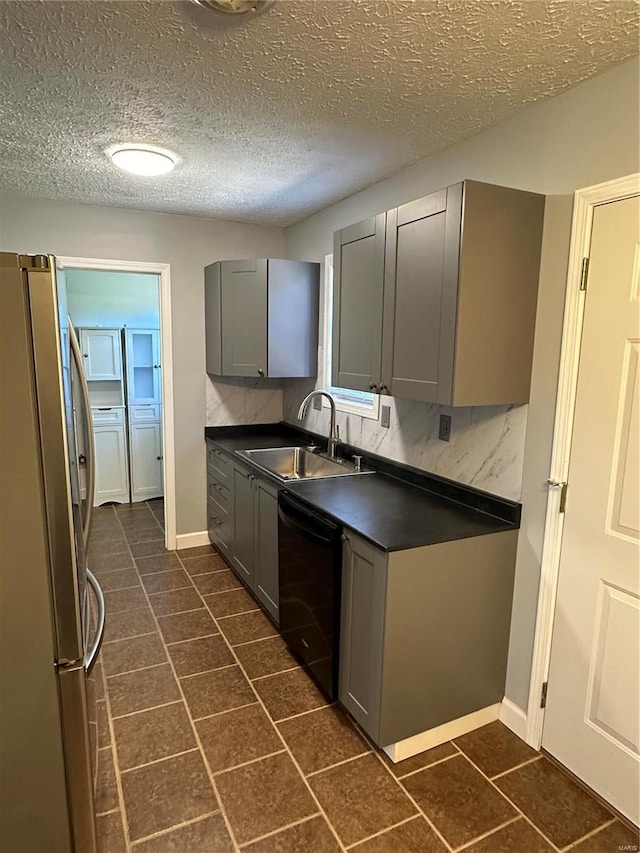 kitchen with gray cabinets, dishwasher, a textured ceiling, and stainless steel refrigerator