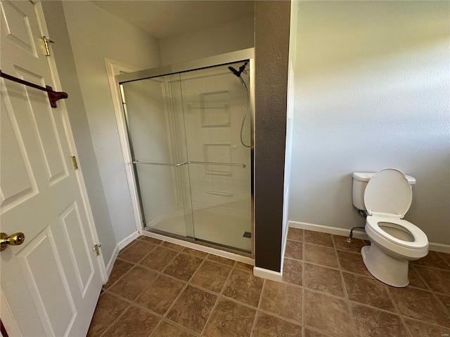 bathroom with toilet and an enclosed shower