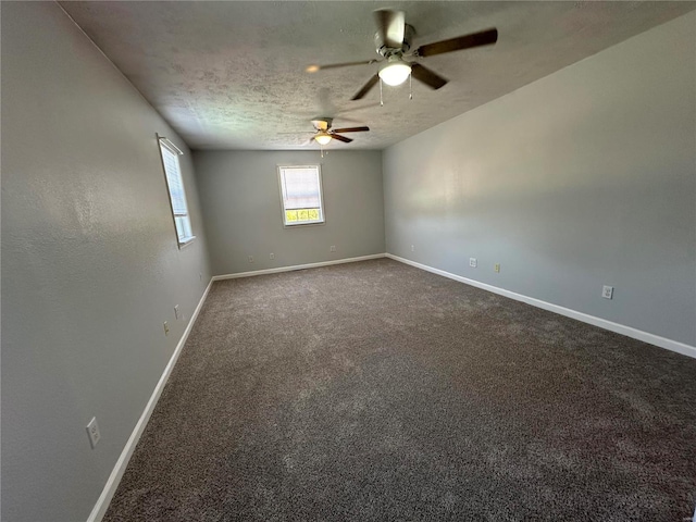 carpeted empty room featuring ceiling fan and a textured ceiling