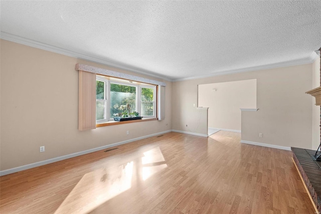 unfurnished living room with light hardwood / wood-style flooring, a textured ceiling, and crown molding