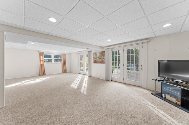 unfurnished living room featuring carpet, french doors, and a paneled ceiling