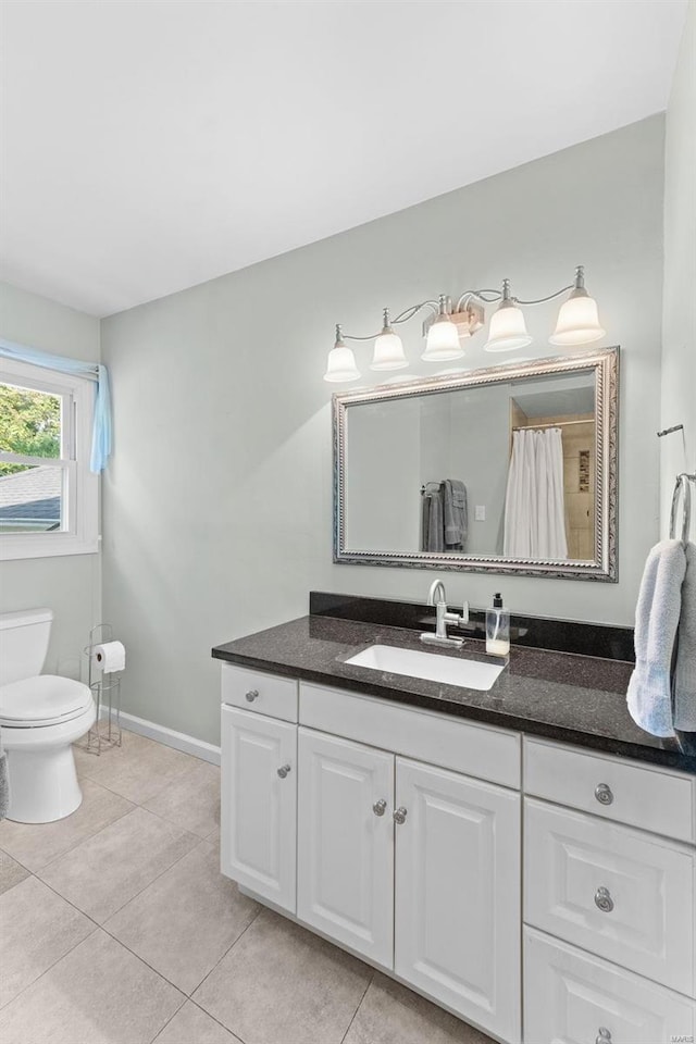 bathroom with tile patterned floors, vanity, and toilet