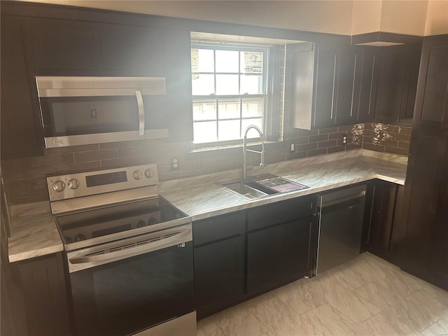 kitchen with sink, dark brown cabinetry, appliances with stainless steel finishes, and tasteful backsplash