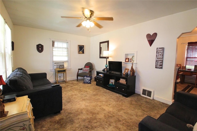 carpeted living room featuring cooling unit and ceiling fan