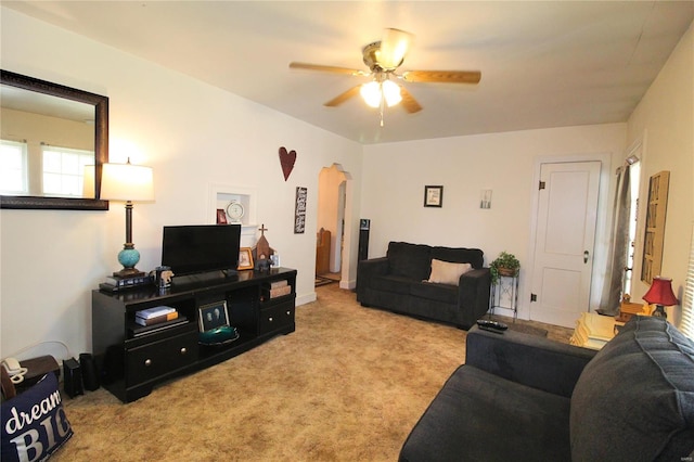 carpeted living room with ceiling fan