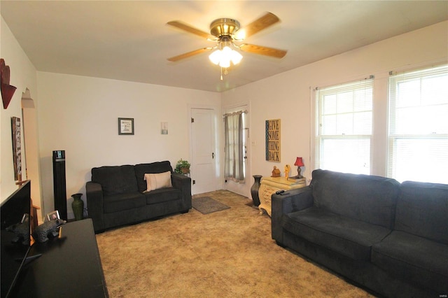 carpeted living room featuring ceiling fan and plenty of natural light