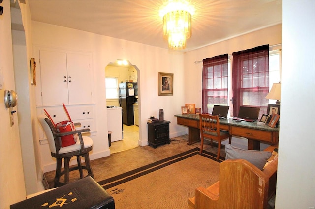 carpeted office with washer / dryer and a notable chandelier