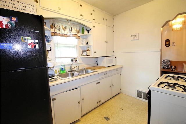 kitchen with white cabinets, white appliances, and sink