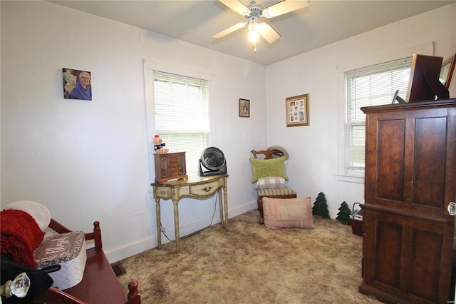 sitting room with light carpet, plenty of natural light, and ceiling fan