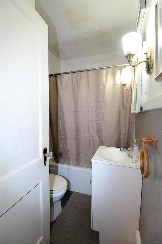 full bathroom with shower / bath combination with curtain, toilet, and vanity