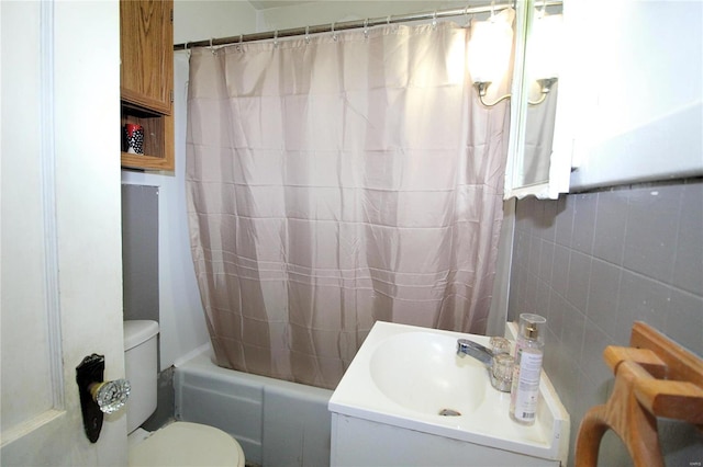 full bathroom featuring tile walls, toilet, vanity, and shower / bathtub combination with curtain