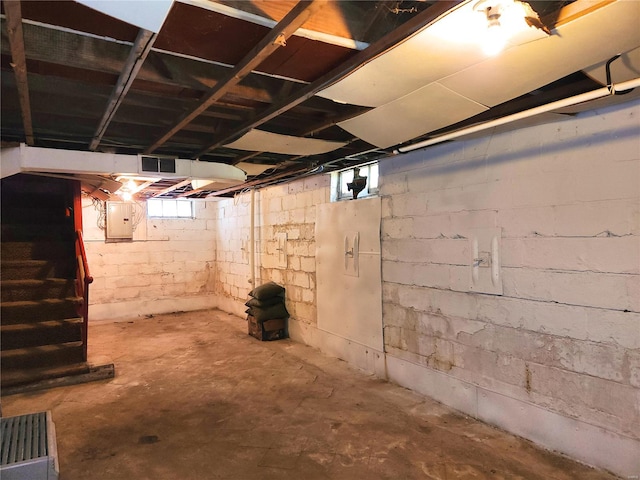 basement with a healthy amount of sunlight and electric panel