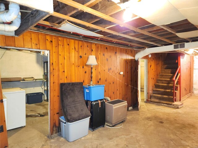 basement with washer / dryer and wood walls