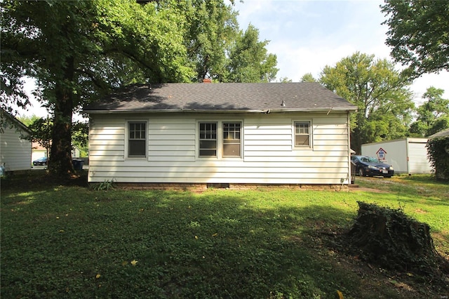 back of house with a yard