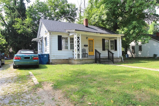 bungalow featuring covered porch and a front lawn