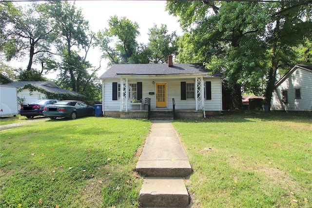 bungalow-style house featuring covered porch and a front yard