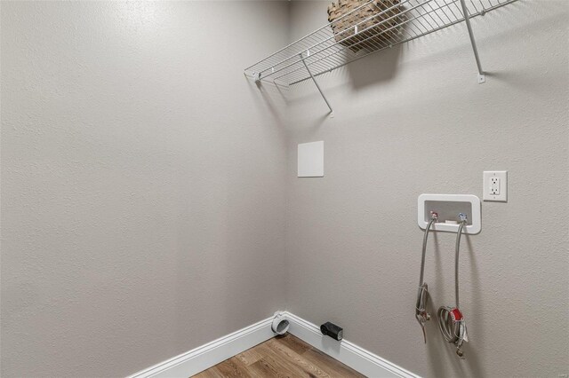 laundry area with hardwood / wood-style flooring and hookup for a washing machine