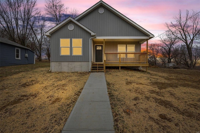 view of front of property with a yard and covered porch