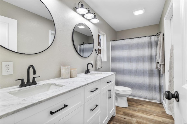 bathroom with vanity, wood-type flooring, toilet, and walk in shower