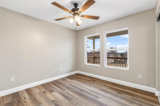 spare room featuring wood-type flooring and ceiling fan