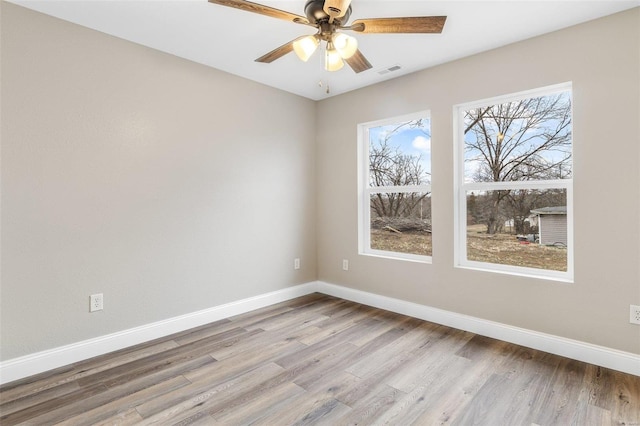 empty room with ceiling fan and light wood-type flooring