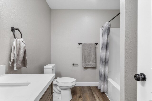 full bathroom featuring shower / bathtub combination with curtain, vanity, wood-type flooring, and toilet