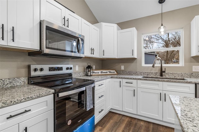 kitchen featuring sink, decorative light fixtures, stainless steel appliances, light stone countertops, and white cabinets