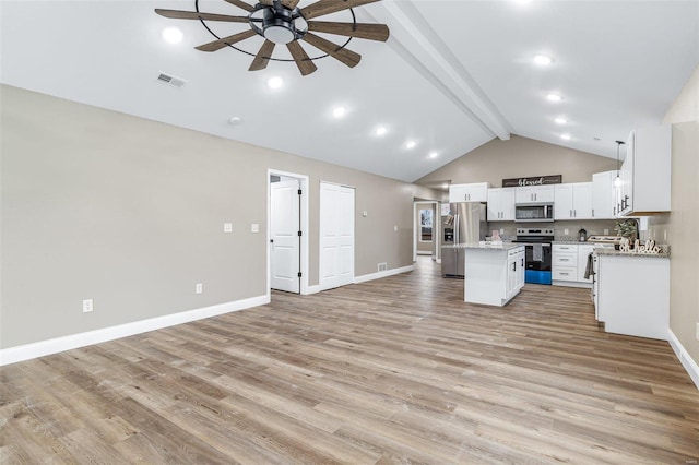 kitchen with light wood-type flooring, a kitchen island, stainless steel appliances, beam ceiling, and white cabinets