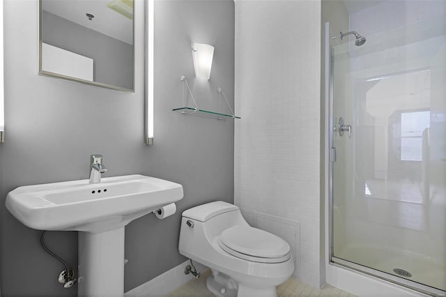 bathroom featuring toilet, an enclosed shower, and tile patterned floors