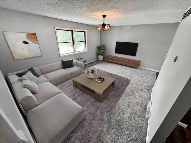 living room featuring carpet and a textured ceiling