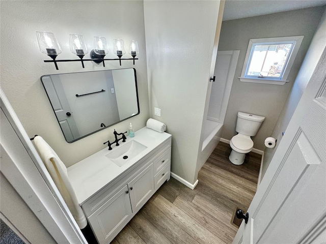 bathroom featuring hardwood / wood-style flooring, vanity, and toilet