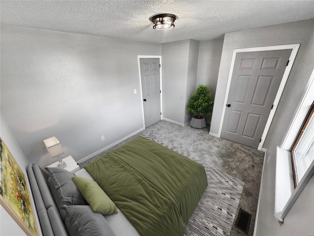 bedroom featuring carpet floors and a textured ceiling