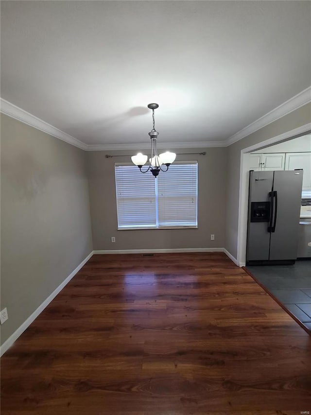 unfurnished dining area featuring a notable chandelier, dark hardwood / wood-style floors, and crown molding