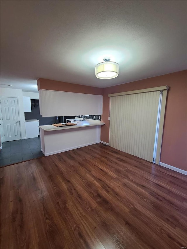 kitchen with dark hardwood / wood-style floors and kitchen peninsula