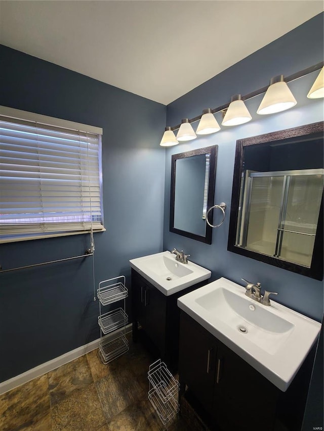 bathroom with vanity and a shower with door